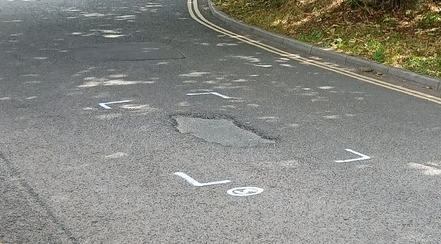 Weston Lane with lots of painted marks signifying repairs to be done where there's not much wrong.