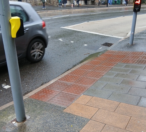 Puddle at kerb of pedestrian crossing